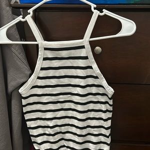 Sleeveless, black and white striped body suit.